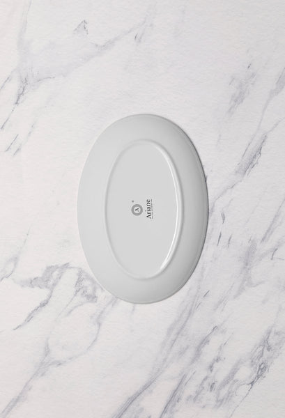 Ariane Vital Coupe 10 1/4" Vital Coupe - Warm White Porcelain Coupe Oval Plate - 12/Case (AVCARN000015026) - iFoodservice Online