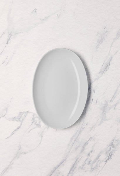 Ariane Vital Coupe 10 1/4" Vital Coupe - Warm White Porcelain Coupe Oval Plate - 12/Case (AVCARN000015026) - iFoodservice Online