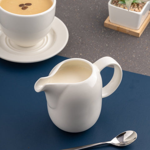 Ariane Vital Coupe 11 5/6 Oz Vital Coupe - Warm White Porcelain Coupe Creamer With Handle - 6/Case (AVCARN000064035) - iFoodservice Online
