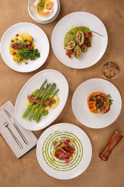 Ariane Vital Coupe 12 1/5" Vital Coupe - Warm White Porcelain Coupe Round Rimless Plate - 6/Case (AVCARN000011031) - iFoodservice Online